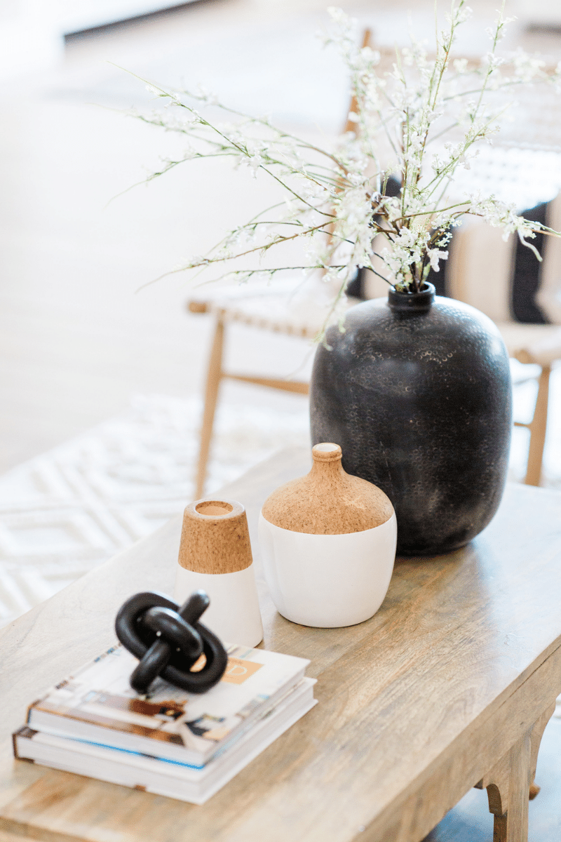 coffee table with books and vases sitting on top