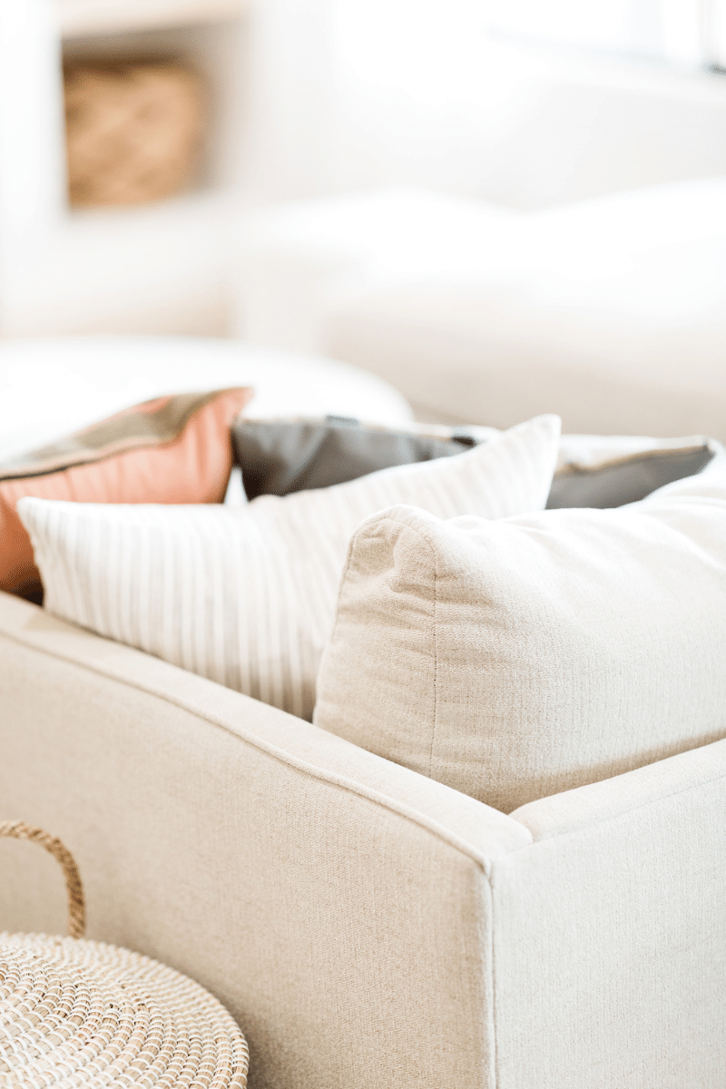 view of a couch corner from the back with pillows peeking over the edge