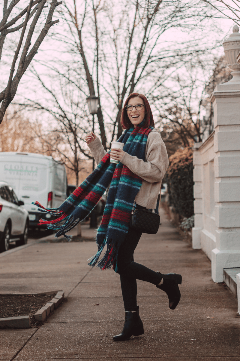 girl walking in city with plaid wool scarf