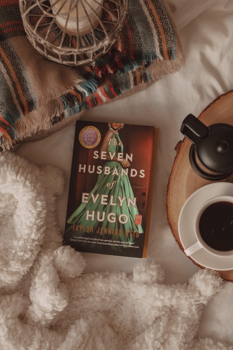 the seven husbands of evelyn hugo by taylor jenkins reid book with fluffy blanket and mug of coffee