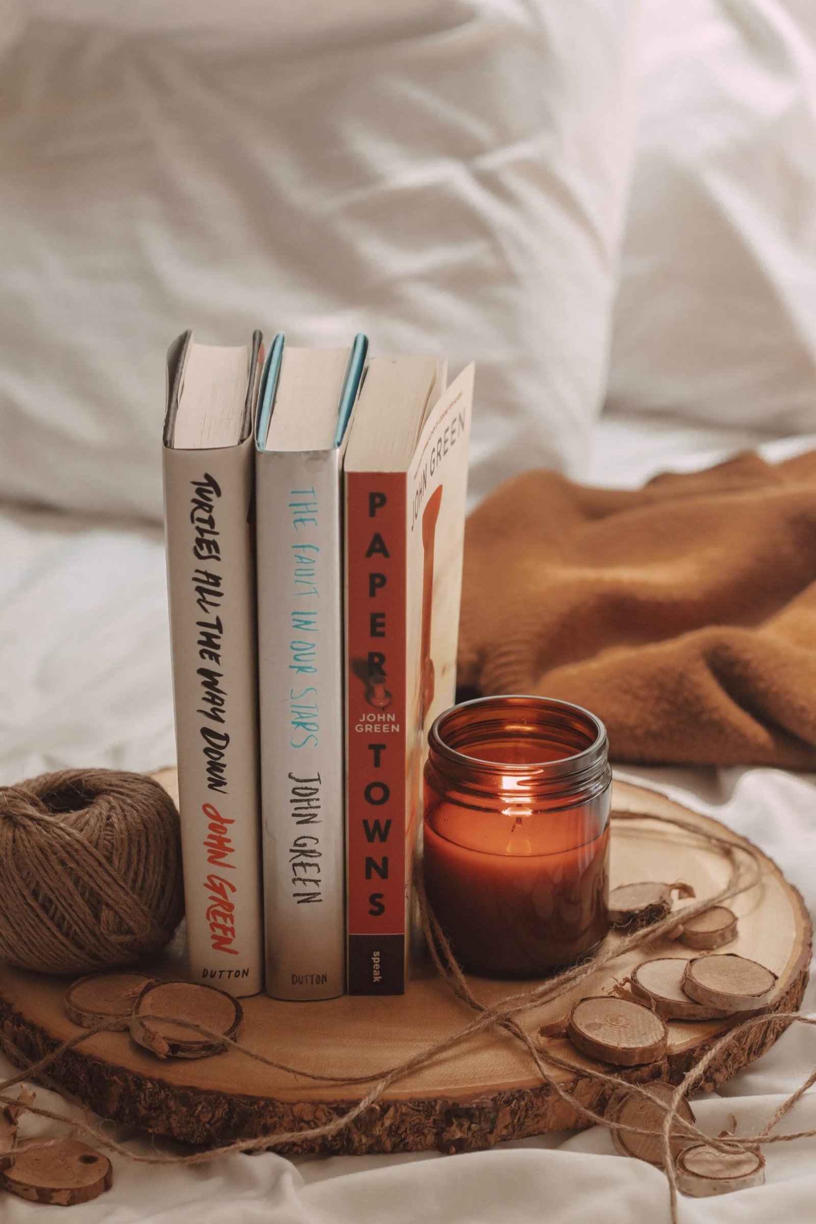 paper towns, the fault in our stars, and turtles all the way down books by john green in between a lit candle and a spool of twine